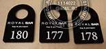 Номерки для гардероба №45 для бара. Нанесение 2-х строк информации и номера. Черные номерки с гравировкой и белой прокраской.